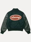 stussy script oval varsity jacket.